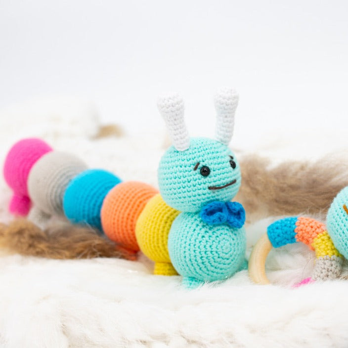 Multicolor 100% hypoallergenic organic cotton crochet caterpillar plush toy.